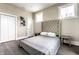 Bright bedroom with a plush upholstered headboard, hardwood floors, and lots of natural light at 952 Elm St, Indianapolis, IN 46203