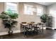 Bright dining room with modern chandelier, dark hardwood floors, and green plants at 952 Elm St, Indianapolis, IN 46203
