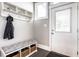 Inviting entryway featuring a bench with storage, coat hooks, and a window for natural light at 952 Elm St, Indianapolis, IN 46203