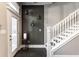 Welcoming foyer with modern decor, dark floors, and a staircase at 952 Elm St, Indianapolis, IN 46203