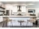 Kitchen island with bar seating, stainless steel appliances, and modern pendant lighting at 952 Elm St, Indianapolis, IN 46203