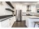 Bright kitchen with stainless steel refrigerator, white cabinets, and dark countertops at 952 Elm St, Indianapolis, IN 46203