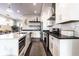 Modern kitchen with white cabinets, stainless steel appliances, and a center island at 952 Elm St, Indianapolis, IN 46203