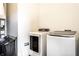Modern laundry room featuring front loading washer and dryer, with shelving and storage space at 952 Elm St, Indianapolis, IN 46203