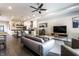 Open-concept living room with a modern sofa, connecting kitchen and dining at 952 Elm St, Indianapolis, IN 46203