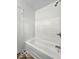 This bathroom features a tub with tiled walls and shower at 9526 Burrwood Ct, Indianapolis, IN 46235