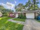 Charming single-story home featuring a two-car garage and a well-maintained front yard at 9526 Burrwood Ct, Indianapolis, IN 46235
