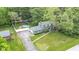 An aerial view of a beautiful two-story home, long driveway, and fenced backyard with playground at 9860 Sunnymeade Ln, Indianapolis, IN 46280
