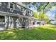 Backyard with patio area, outdoor seating, and a lush green lawn at 9860 Sunnymeade Ln, Indianapolis, IN 46280