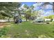 Wide backyard with a playset and a greenhouse in a fenced in yard at 9860 Sunnymeade Ln, Indianapolis, IN 46280