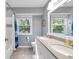 Bright bathroom featuring double sinks, granite countertops, and stylish fixtures at 9860 Sunnymeade Ln, Indianapolis, IN 46280