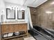 Modern bathroom with double vanity, tile shower, and soaking tub at 9860 Sunnymeade Ln, Indianapolis, IN 46280