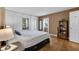 Bedroom featuring hardwood floors, built-in storage, and natural light at 9860 Sunnymeade Ln, Indianapolis, IN 46280