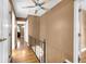 Hallway with wood floors and iron railing leading to various rooms at 9860 Sunnymeade Ln, Indianapolis, IN 46280