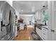 Modern kitchen with white cabinets, stainless steel appliances, wood floors and eat-in kitchen area at 9860 Sunnymeade Ln, Indianapolis, IN 46280