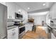 Bright kitchen with white cabinets, stainless steel appliances, gray counters and eat-in kitchen bar at 9860 Sunnymeade Ln, Indianapolis, IN 46280