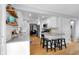 Spacious kitchen offers white cabinetry, stainless steel appliances, hardwood flooring, and bar seating at 9860 Sunnymeade Ln, Indianapolis, IN 46280