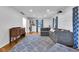 Open living room showcasing hardwood floors, projector, gray sectional, and built-in shelving at 9860 Sunnymeade Ln, Indianapolis, IN 46280