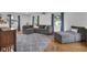 Bright living room with hardwood floors, gray sectional, and blue accent curtains at 9860 Sunnymeade Ln, Indianapolis, IN 46280
