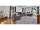 Comfortable living room featuring hardwood floors, large gray sectional, and natural light at 9860 Sunnymeade Ln, Indianapolis, IN 46280
