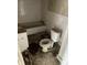 Bathroom with dated fixtures, including a toilet, sink, and bathtub at 1014 W 33Rd St, Indianapolis, IN 46208