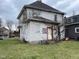 Exterior view of two-story home with overgrown vines at 1014 W 33Rd St, Indianapolis, IN 46208