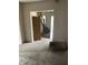 View of a living room space with torn up carpet and entrance to staircase at 1014 W 33Rd St, Indianapolis, IN 46208