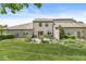 Expansive backyard featuring a stone patio with outdoor furniture and lush landscaping surrounding the home at 10143 Winslow Way, Fishers, IN 46037