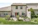 Backyard view of patio, garden, and the home's exterior at 10143 Winslow Way, Fishers, IN 46037
