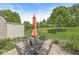 Backyard with stone patio, lawn, and an open view of the property's landscape at 10143 Winslow Way, Fishers, IN 46037