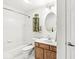 Bright bathroom featuring a tub/shower combination and a classic vanity with oak cabinetry at 10143 Winslow Way, Fishers, IN 46037