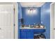 Bright blue powder room featuring custom vanity with a marble countertop and stylish decor at 10143 Winslow Way, Fishers, IN 46037