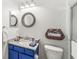 Compact bathroom with vanity and decorative mirror, complemented by a glass enclosed shower and stylish accents at 10143 Winslow Way, Fishers, IN 46037