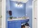 Bathroom featuring blue vanity with marble countertop, modern light fixtures, and white fixtures at 10143 Winslow Way, Fishers, IN 46037