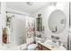 Clean bathroom with a tub, shower, floral shower curtain, a mirrored vanity, and ample lighting at 10143 Winslow Way, Fishers, IN 46037