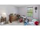 Bedroom filled with furniture and miscellaneous items, featuring a view of the outdoors from the window at 10143 Winslow Way, Fishers, IN 46037