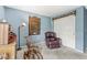 Bedroom with light blue walls featuring sitting furniture, storage furniture, and white closet doors at 10143 Winslow Way, Fishers, IN 46037
