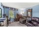 Cozy blue bedroom with a large window, a comfortable recliner, and vintage decor at 10143 Winslow Way, Fishers, IN 46037