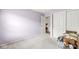 Bedroom featuring light purple walls, closet doors, white trim, and a door leading to another room at 10143 Winslow Way, Fishers, IN 46037