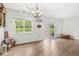 Dining area with hardwood floors, a chandelier, and a large window overlooking the backyard at 10143 Winslow Way, Fishers, IN 46037