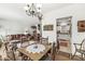 A dining room flows into the living room and features an antique table and decor throughout at 10143 Winslow Way, Fishers, IN 46037