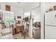 Cozy entryway featuring vintage decor, neutral tile flooring, and an inviting glimpse into the living room and dining area at 10143 Winslow Way, Fishers, IN 46037