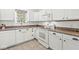 Well-lit kitchen with white cabinets, granite countertops, and modern appliances at 10143 Winslow Way, Fishers, IN 46037