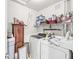 Functional laundry room with washer, dryer, cabinet, and storage shelving for cleaning supplies at 10143 Winslow Way, Fishers, IN 46037