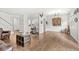 Spacious living area with hardwood floors, an antique sewing machine, and a view into the kitchen at 10143 Winslow Way, Fishers, IN 46037