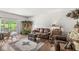 Bright living room featuring hardwood floors, neutral walls, natural light, and a sliding glass door to the patio at 10143 Winslow Way, Fishers, IN 46037