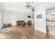 Open-concept living space with hardwood floors, comfortable seating, and a view of the staircase and kitchen at 10143 Winslow Way, Fishers, IN 46037