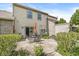 Back patio area with a metal table and chairs, set in a brick-paved landscape with an orange umbrella for shade at 10143 Winslow Way, Fishers, IN 46037
