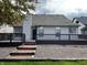 Spacious backyard featuring a large deck, stone ground cover, and brick steps leading to the yard at 10305 Lakeland Dr, Fishers, IN 46037
