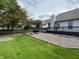 Expansive backyard with a wooden deck, gravel area, and green grass, partially fenced at 10305 Lakeland Dr, Fishers, IN 46037